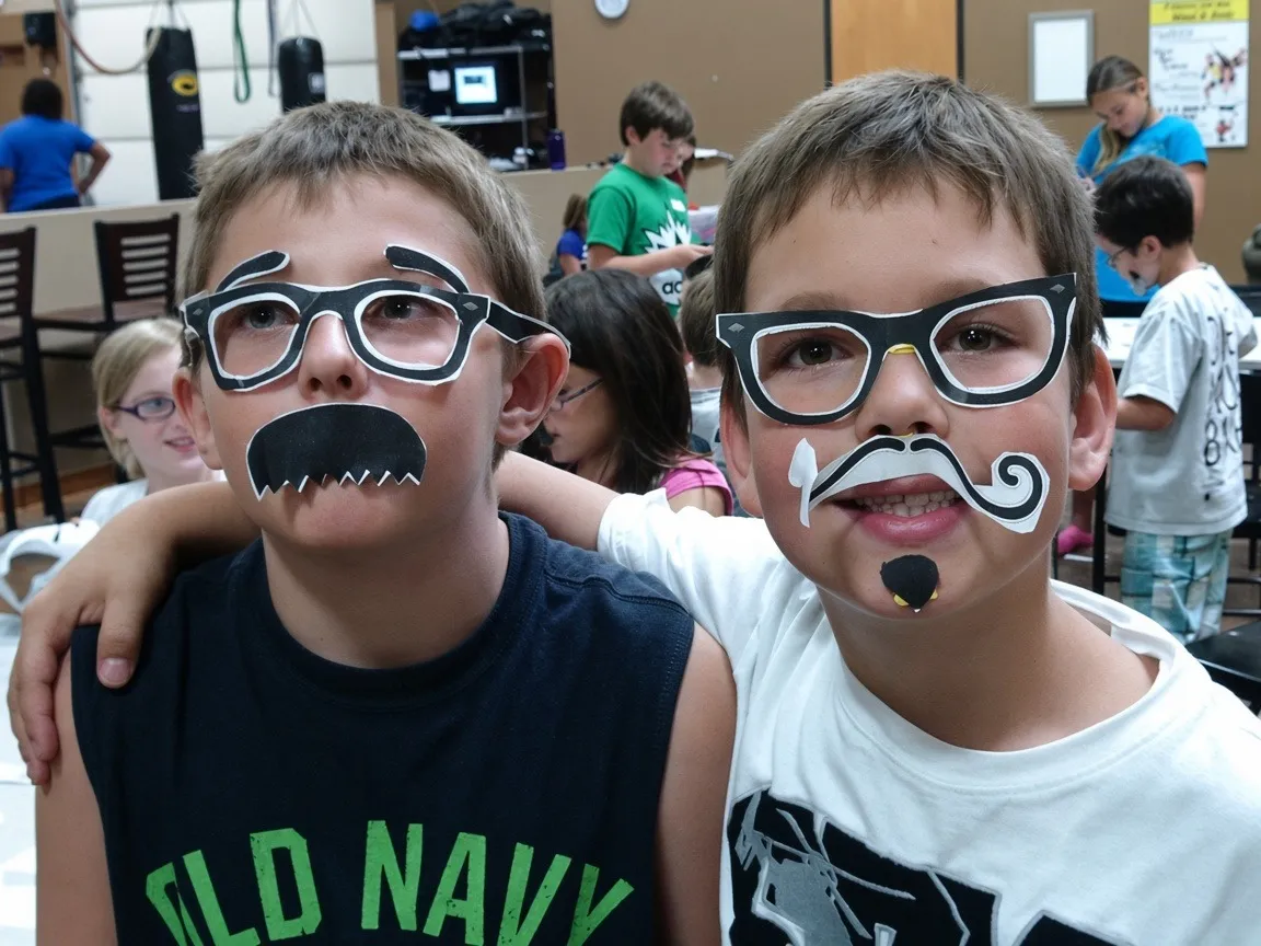 Two school-age boys in silly glasses